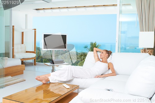 Image of Woman relaxing in spacious bright living-room