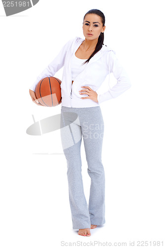 Image of Woman standing and holding basketball