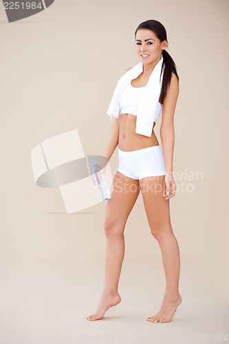 Image of Full body shot of smiling sporty girl