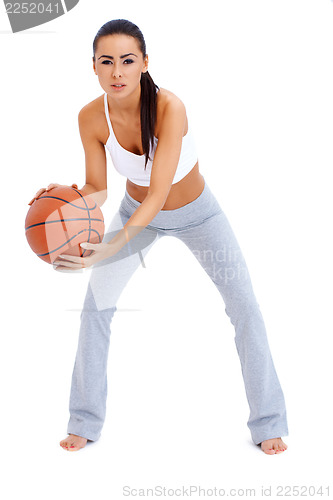 Image of Woman standing and holding basketball