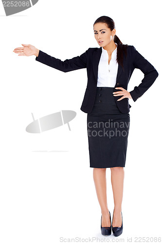 Image of Business woman standing and pointing at copy space