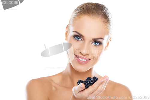 Image of Smiling healthy woman with blackberries