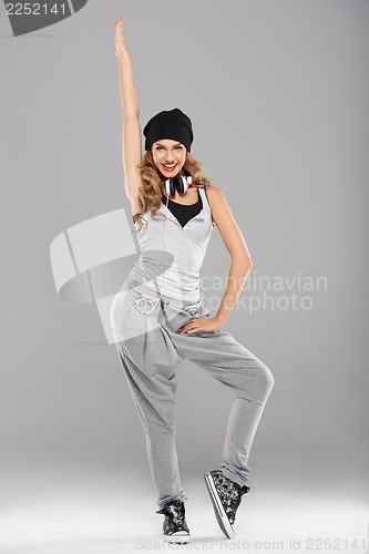 Image of Female modern dancer posing on grey