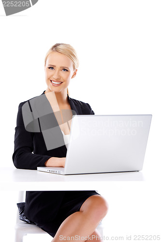 Image of Smiling business woman using laptop computer