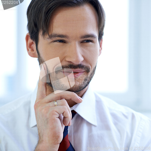 Image of Smiling man lost in thought