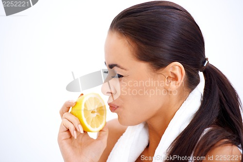 Image of Woman holding lemon while making a face