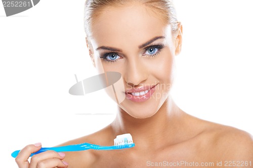Image of Closeup of beautiful young lady holding toothbrush