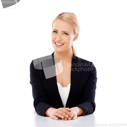 Image of Beautiful smiling business woman sitting at the desk