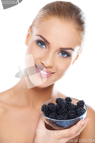 Image of Smiling girl holding blackberries on hand