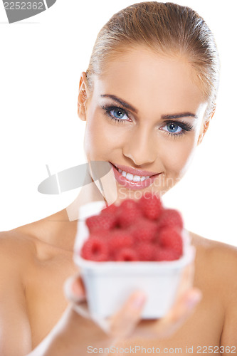 Image of Beautiful woman with punnet of raspberries
