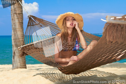 Image of Beautiful cute girl relaxing in a hammock