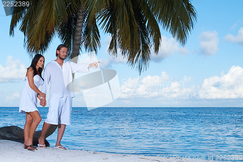 Image of Couple nex to Palm tree