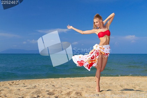 Image of Adorable woman standing at the tropical beach