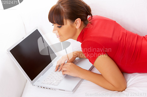 Image of Girl with laptop on couch