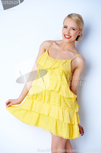 Image of Pretty elegant woman wearing yellow dress