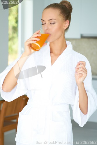 Image of Woman enjoying a glass of orange juice