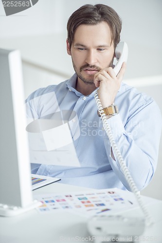 Image of Businessman working at the desk