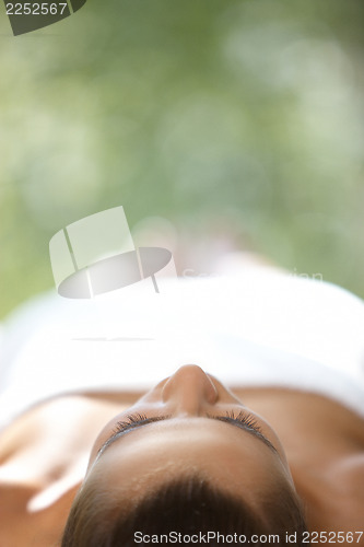 Image of Beautiful woman is resting on spa bed