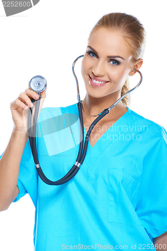 Image of Pretty young doctor holding her stethoscope while isolated