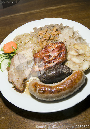 Image of typical food Slovenia black pudding fried sausage dried pork cho