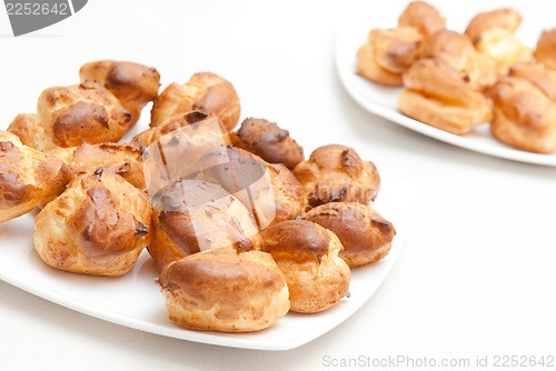 Image of delisious profiteroles on the white plate