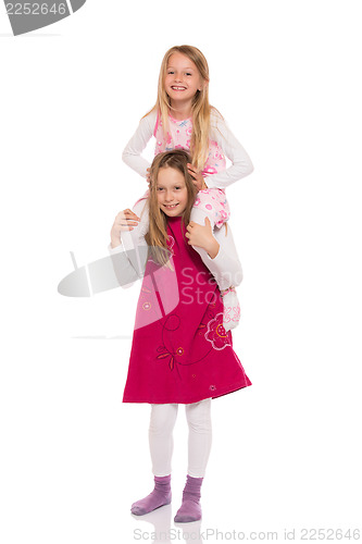 Image of Young girl giving piggyback ride
