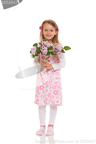 Image of Smiling little girl with lilac flowers