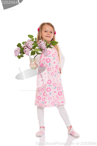 Image of Smiling little girl with lilac flowers