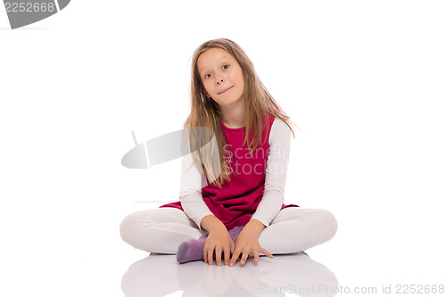 Image of Young girl making faces on the floor