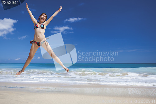 Image of Woman jumping on the beach