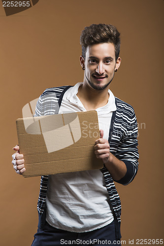 Image of Young man holding a card board