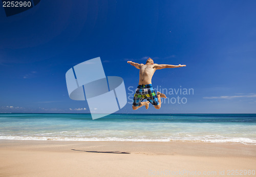 Image of Man jumping on the beach