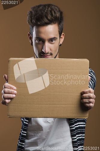 Image of Young man holding a card board