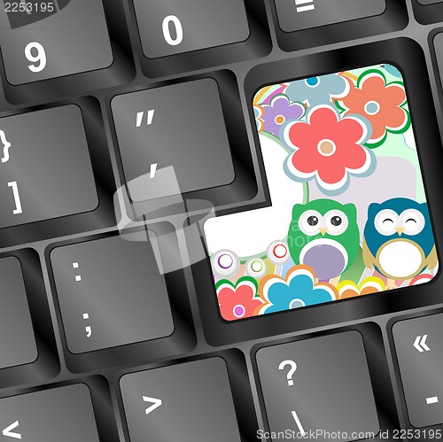 Image of owl family and flowers on computer keyboard key