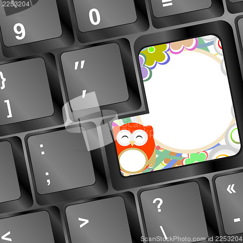 Image of owl and flowers on computer keyboard key