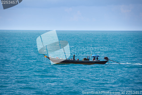 Image of Old fishing boat goes by sea - fishermen working