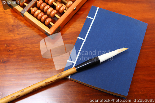 Image of Chinese book , abacus and writing brush