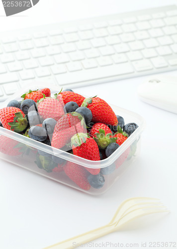 Image of Berry mix lunch on working desk in office 