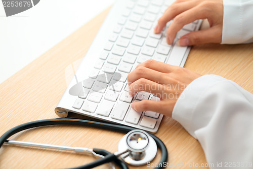Image of Doctor typing on keyboard with stethoscope