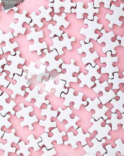 Image of White puzzle on pink background