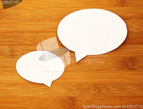 Image of paper speech bubble on wood background