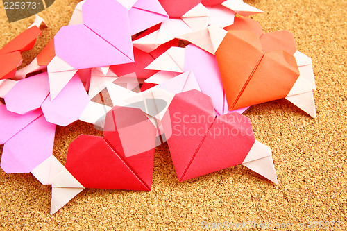 Image of Origami colorful heart on corkboard 