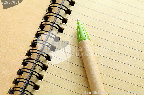Image of spiral notebook with pen