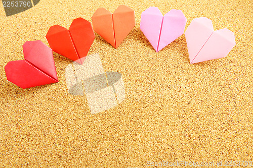 Image of Origami colorful heart on corkboard 