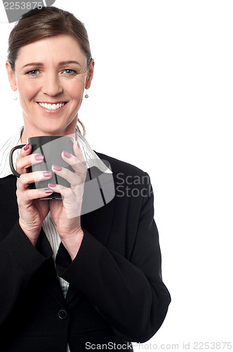 Image of Pretty female manager enjoying her coffee