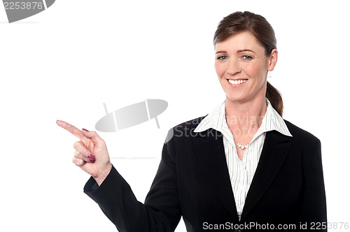 Image of Smiling professional lady pointing away