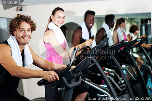 Image of People at gym working out happily