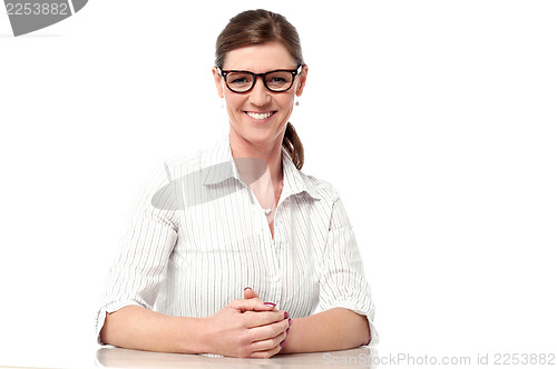 Image of Professional woman at her desk, smiling