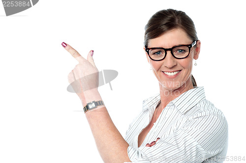 Image of Attractive business lady pointing away