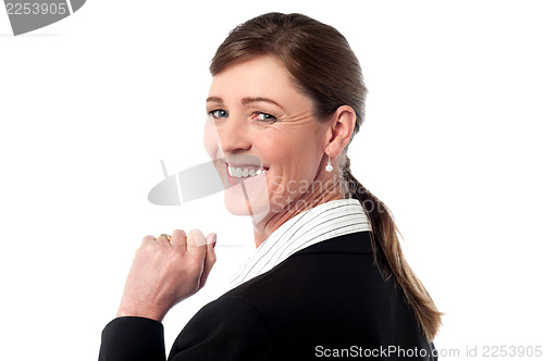 Image of Business woman turns back and looks over